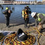 Divers entering the water for a flat patch installation.